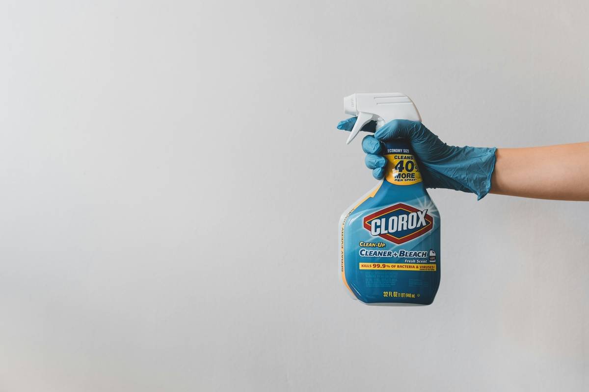 Airbrush submerged in what is airbrush cleaning solution inside ultrasonic cleaner